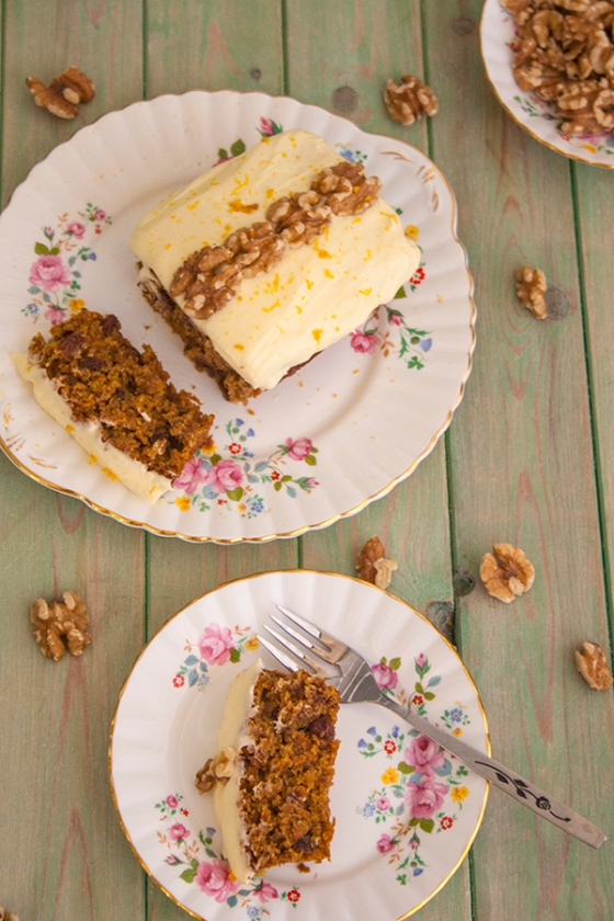 Carrot and orange cake slice with cream cheese icing and walnuts